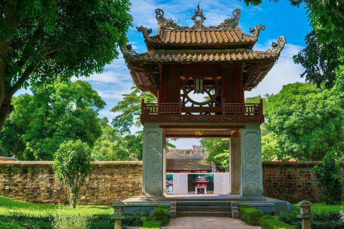 Peaceful inner courtyard of Temple of Literature Hanoi, surrounded by lush trees and historical buildings